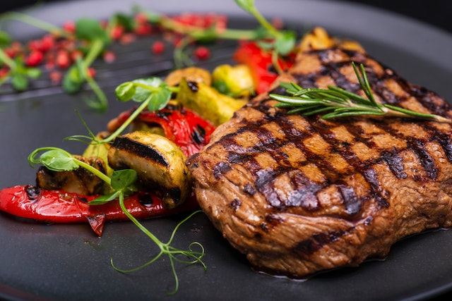 grilled-meat-and-vegetables-with-herb-garnish
