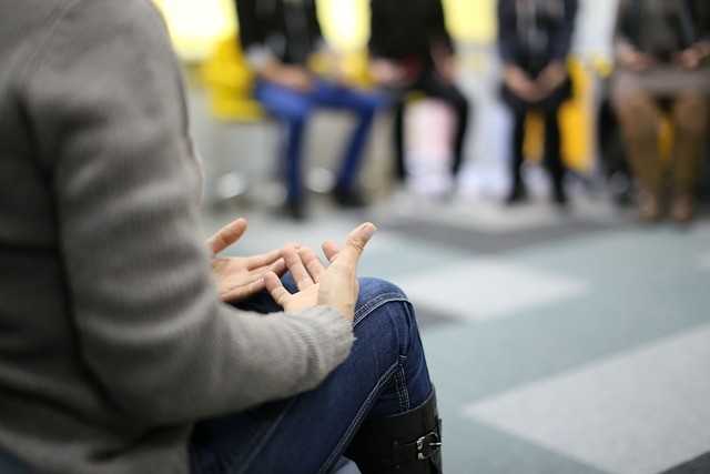 a woman speaks in group therapy