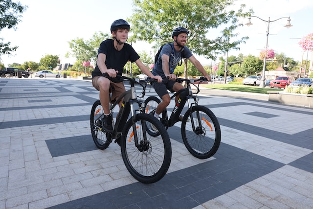 two guys on bicycles wearing helmets