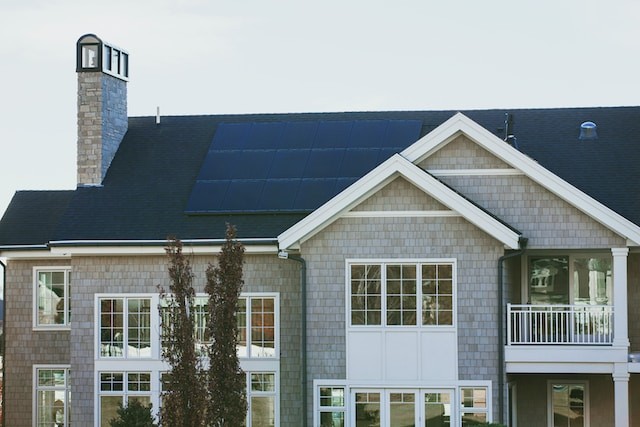 gray concrete house with solar panels on roof