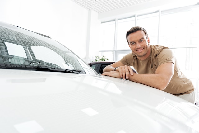 person with his car