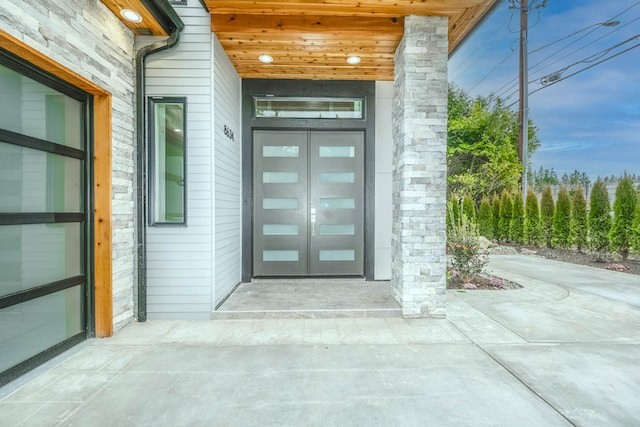 gray wooden door near green plants