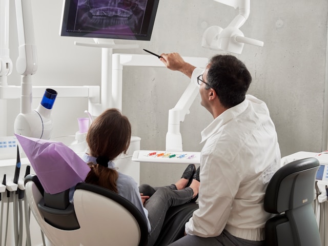 dentist and patient looking at xray