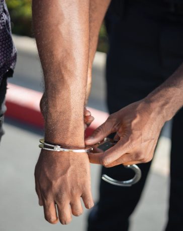 police-officer-putting-handcuffs-on-another-person