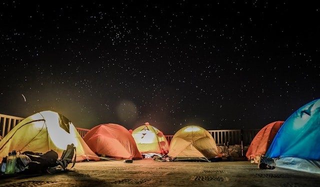 assorted-color-dome-tents-beside-fence