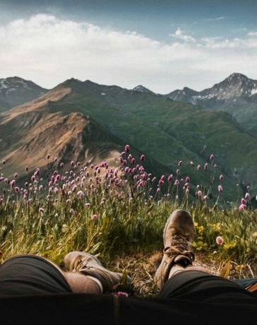 person-lying-inside-tent-and-overlooking-mountain