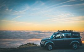 grey-suv-beside-sea-of-cloud