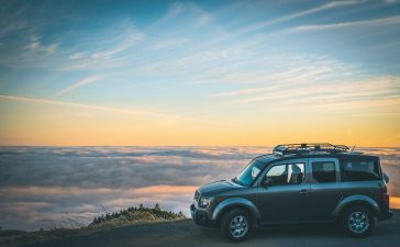 grey-suv-beside-sea-of-cloud