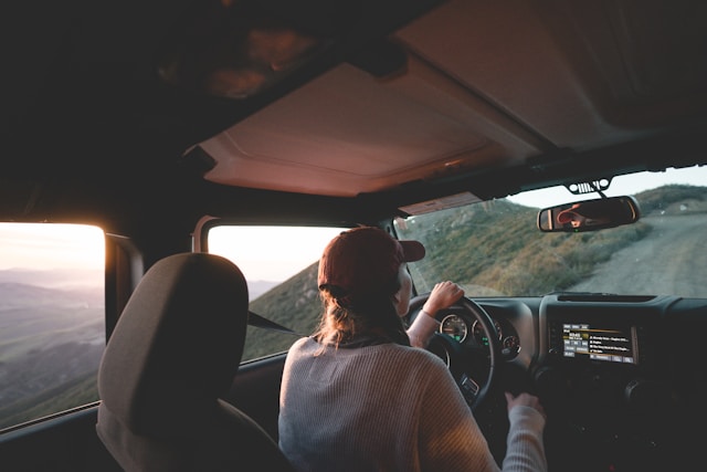 woman-driving-vehicle-on-road-during-daytime