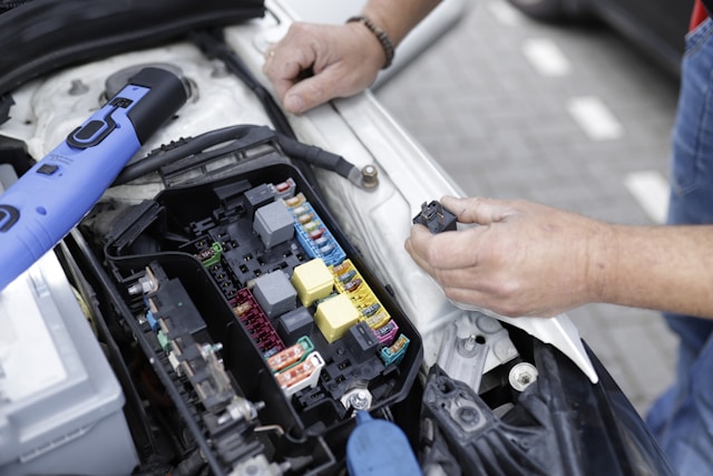 a-man-is-working-on-a-cars-engine