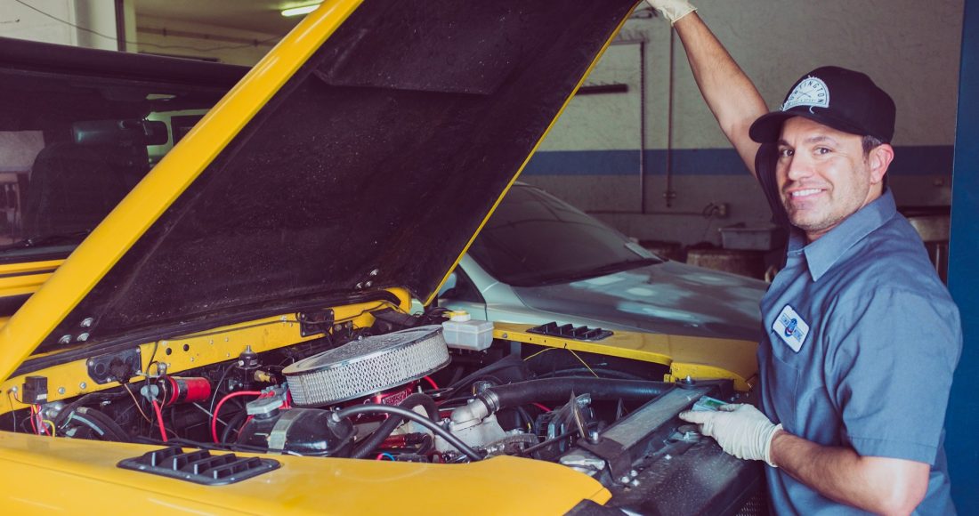 man-holding-open-wide-car-trunk