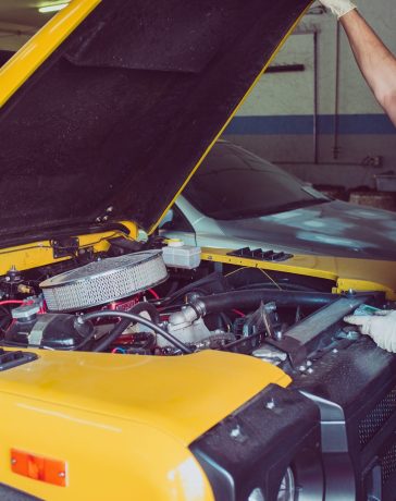 man-holding-open-wide-car-trunk