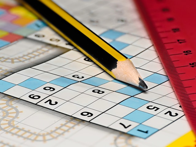a-pencil-sitting-on-top-of-a-piece-of-paper-next-to-a-ruler-
