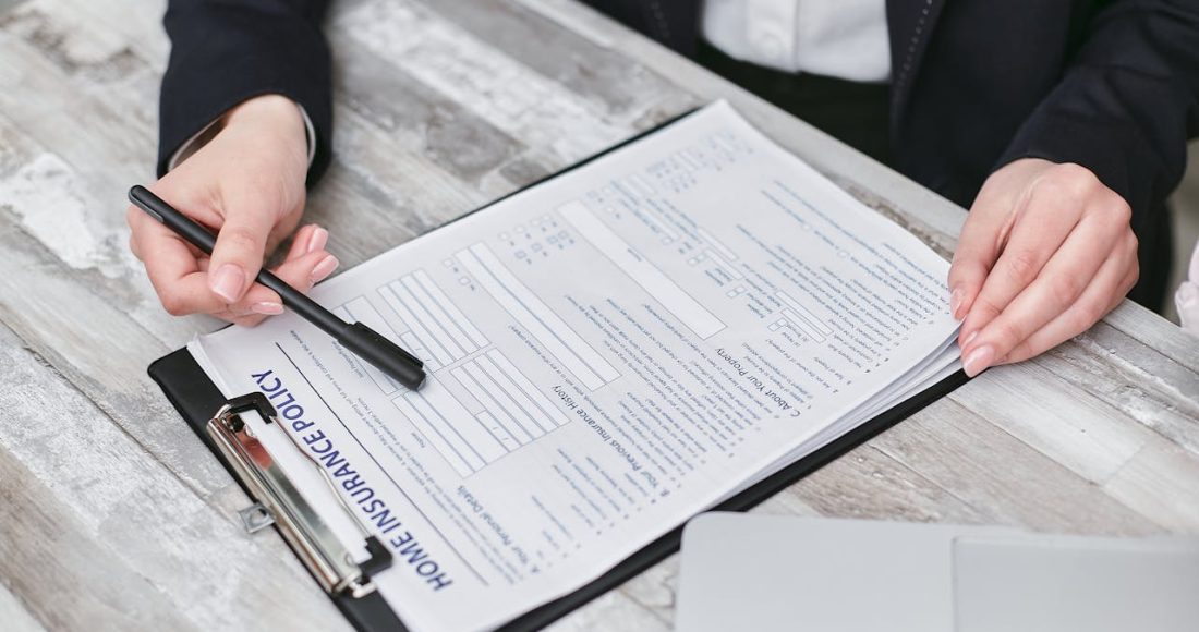 a-person-holding-a-black-pen