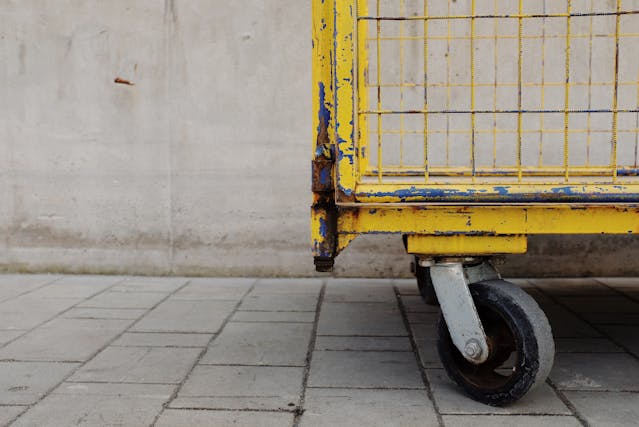 yellow-and-black-metal-cart-on-gray-concrete-floor