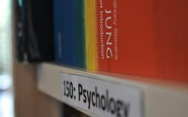 a-close-up-of-a-book-shelf-with-books-on-it