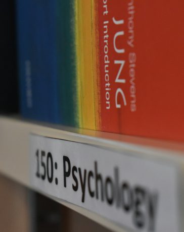 a-close-up-of-a-book-shelf-with-books-on-it